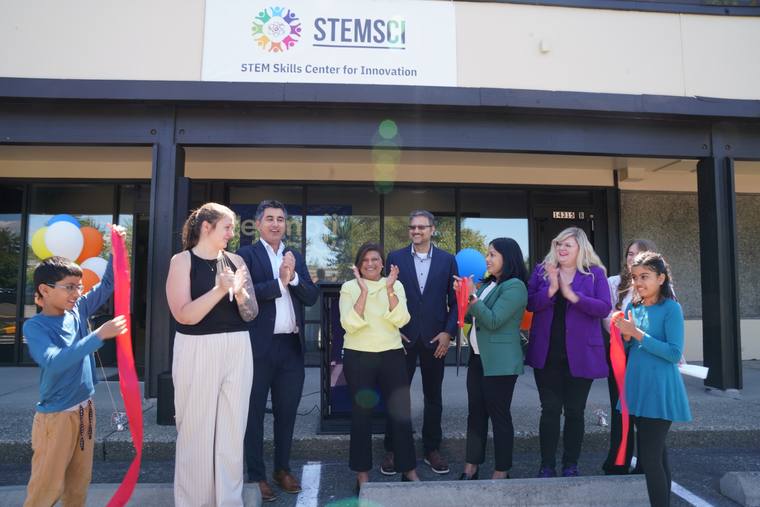 The group gathered with the cut ribbon